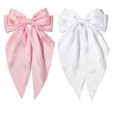 Furling Pompoms pink hair bow clip for women, adds elegant flair.