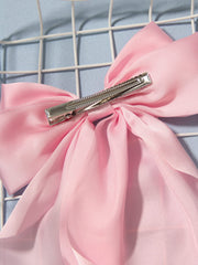 Furling Pompoms satin bow detail adds chic touch to hairstyles