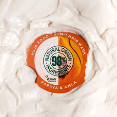 Garnier Hair Food Papaya 3-in-1 mask applied to damp hair for nourishment.