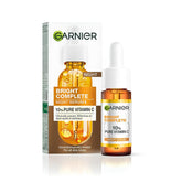 Garnier Targeted Anti Dark Spot Night Serum bottle closeup highlights 10% Vitamin C for brightening.