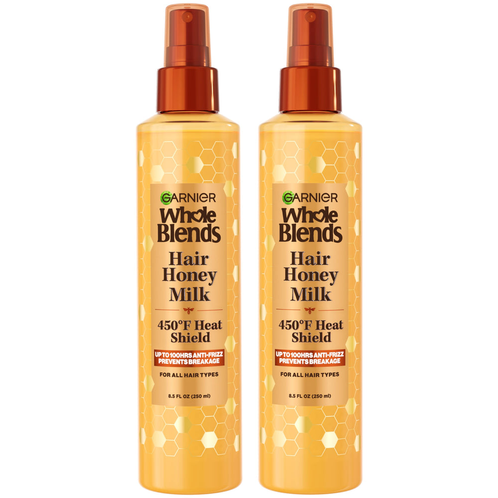 Garnier Whole Blends Hair Honey Milk heat-protectant spray bottle provides 450F protection for all hair types.