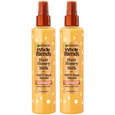 Garnier Whole Blends Hair Honey Milk heat-protectant spray bottle provides 450F protection for all hair types.