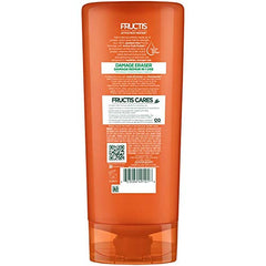 Garnier Fructis Damage Eraser Conditioner being applied to hair, highlighting root-to-tip strengthening.