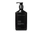 Gilchrist & Soames Warm Oak Shampoo bottle pour showcases easy cleansing for all hair types.