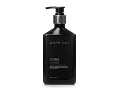 Gilchrist & Soames Warm Oak Shampoo bottle pour showcases easy cleansing for all hair types.
