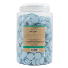 Ginger Lily Farms Botanicals dissolving tablet in water demonstrates quick effervescence for foot soak.