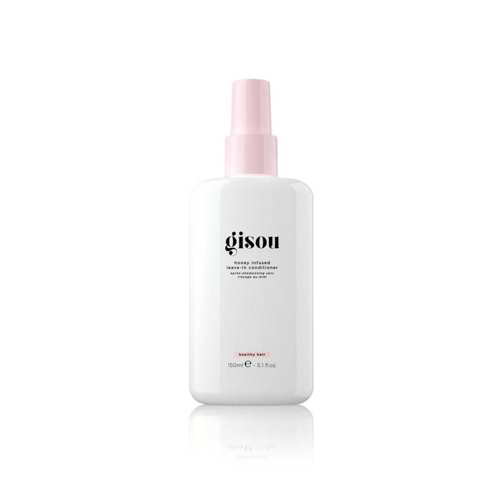 Gisou Honey Infused Leave-In Conditioner bottle on vanity for detangling and shine.