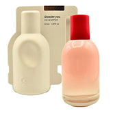 Glossier You bottle closeup highlights minimalist design for everyday wear.