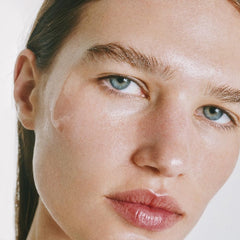 goop Beauty Exosome Hydration Therapy Serum being massaged into cheek demonstrates glow-enhancing hydration