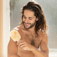 GranNaturals dry brushing in the shower illustrates exfoliation routine.