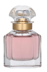 Guerlain Mon Guerlain bottle cap detail with gold accents conveys timeless luxury.