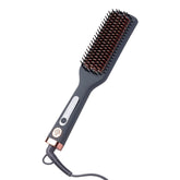 Hairitage heated ceramic straightening brush close-up with even heat for smoother, frizz-controlled styling.