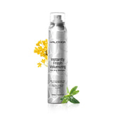 HALOVIDA Dry Shampoo bottle releasing a fine mist to prevent white residue on dark hair.