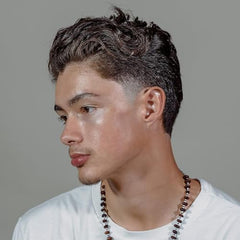 Hanz de Fuko Hybridized Wax satin shine on hair strands for natural glow.