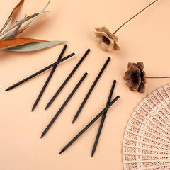 Hariendny hole-top sticks providing grip for textured braids and buns.