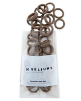 Heliums extra-small hair ties light brown close-up shows seamless design for delicate styles.