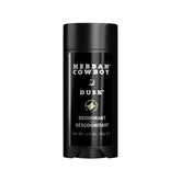 Herban Cowboy Dusk aloe-infused deodorant stick in hand, offering aluminum-free daily freshness.