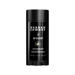 Herban Cowboy Dusk aloe-infused deodorant stick in hand, offering aluminum-free daily freshness.