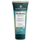 Herbatint Hydrate Conditioner bottle pours, signaling deep hydration for soft, manageable hair.