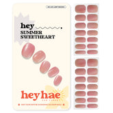Heyhae rose hue semi-cured nail strips closeup with painterly finish.