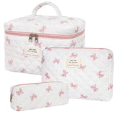 Honitty makeup bag with quilted floral pattern keeps cosmetics organized on the go.