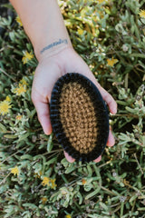 HOT HAVEN dry brush in action for radiant skin exfoliation.