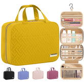 HOTOR travel toiletry bag in yellow hanging closed for compact storage.