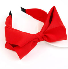 Huachi red bow headband worn on head shows secure all-day comfort.