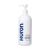 Huron Men Moisturizing Body Wash bottle with sandalwood label promotes refreshing daily cleansing.