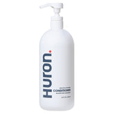 Huron Men's Conditioner bottle provides lightweight hydration and frizz control.