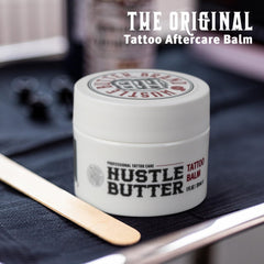 Hustle Butter Deluxe creamy-texture close-up highlights natural ingredients like shea and coconut for moisture.