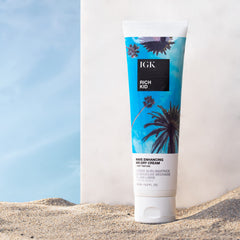 IGK Rich Kid applying cream to damp hair to create texture and definition.