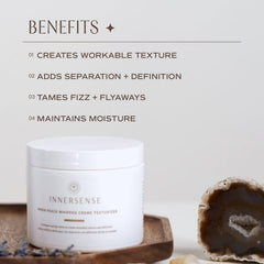 INNERSENSE hair-styling cream in hands for defining texture.