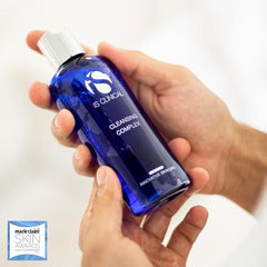 iS CLINICAL Cleansing Complex makeup-removal image highlights one-step cleansing with toning and mild exfoliation.