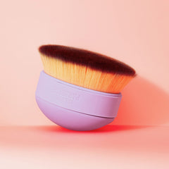 Isle of Paradise Shape and Glow brush shown palm-size for easy face and body use.