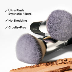 Applying liquid foundation with IT Cosmetics brush for even, buildable coverage.