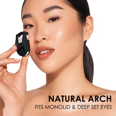 JAPONESQUE Travel Eyelash Curler in-use demonstrates precise curl lift for natural-looking lashes.