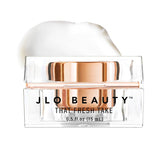 JLO BEAUTY Under Eye Cream jar closeup highlighting hydrating formula for refreshed eyes.