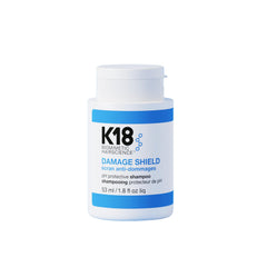 K18 Damage Shield bottle pour shows easy application and color-safe cleansing.