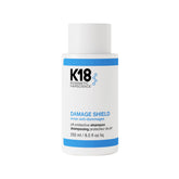 K18 Damage Shield shampoo bottle front — color-safe cleansing in action.