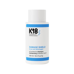 K18 Damage Shield shampoo bottle front — color-safe cleansing in action.