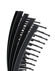 KareCo Tangle Buster Brush ultra-flexible paddle adapts to scalp for tug-free detangling.