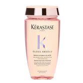 KÉRASTASE Gloss Absolu shampoo bottle closeup with hydrating, shine-boosting formula.
