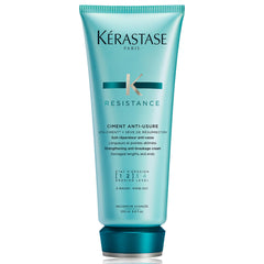 KÉRASTASE Resistance Ciment Anti-Usure bottle pouring, signaling restorative care for damaged hair