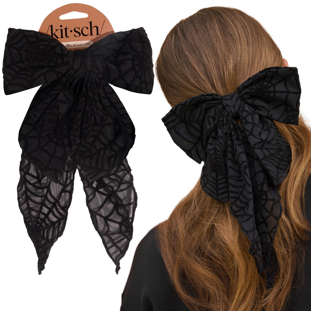 Kitsch black ribbon hair clip closeup showing bold bow for everyday outfits and party looks