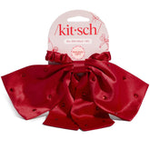 Kitsch satin scrunchie rhinestone bow close-up; festive sparkle for parties.