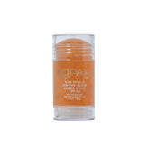 Kopari Sun Shield On-The-Glow stick in hand for on-the-go protection
