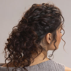 Kristin Ess curl leave-in cream application scene highlighting detangling during styling.