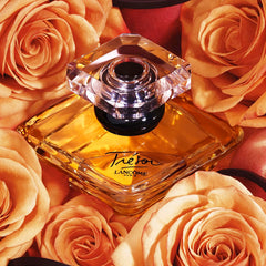 Lancôme Trésor crystal pyramid bottle with gold cap.