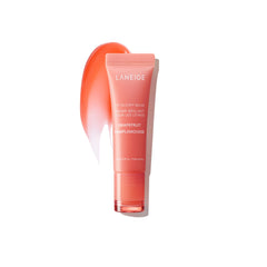 LANEIGE Lip Glowy Balm Grapefruit tube close-up shows glossy hydration.